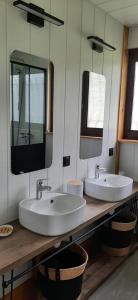 a bathroom with two sinks and two mirrors at Maison familiale à Gerde in Gerde +52 photos