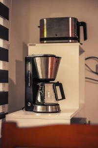 a coffee maker sitting on top of a counter at GottwaldHaus-Freiberg-Apartment C in Freiberg +4 photos