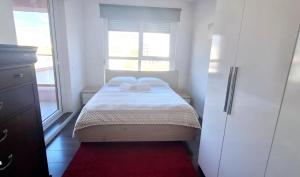 a small bedroom with a bed and a window at Modern Mountain View P&E Tirana Apartment Netflix included in Tirana