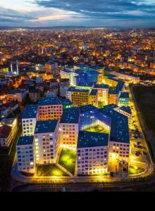 a large building with blue roofs in a city at night at Modern Mountain View P&E Tirana Apartment Netflix included in Tirana +17 photos