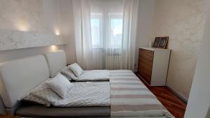 a bedroom with a bed and a dresser and a window at Bella Vista Superior in Umag