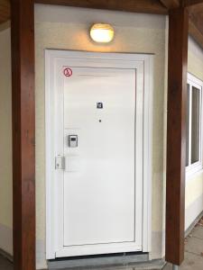 a white garage door with a light on top at GottwaldHaus-Freiberg-Apartment E in Freiberg