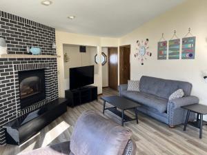a living room with a couch and a fireplace at Harbor Inn Algoma in Algoma
