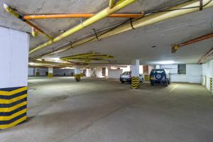 an empty parking garage with cars parked in it at Hotel Axis Inn By GEH Suites in Santa Marta