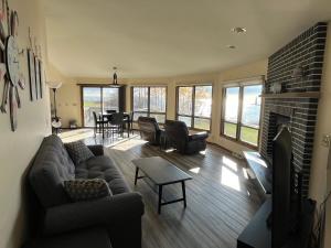 a living room with a couch and a fireplace at Harbor Inn Algoma in Algoma