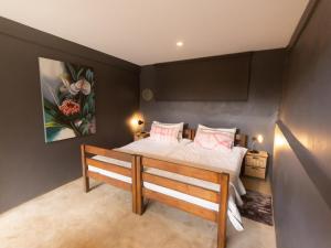 a bedroom with a bed with pink pillows at La Hacienda in uMhlali