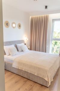 Un dormitorio con una cama grande y una ventana. en K&M Apartments Near Tauron Arena, en Cracovia