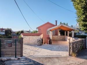 a house with a gate and a fence at Villa Badi in Malinska