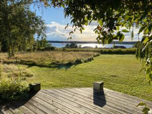 a wooden deck with a view of the water at Sunset over water, 50 mins from Copenhagen in Skibby