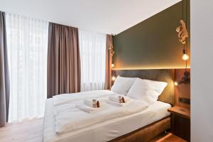 Postel nebo postele na pokoji v ubytování JUNGLE No5 Boutique Hotel - Stuttgart City-Center