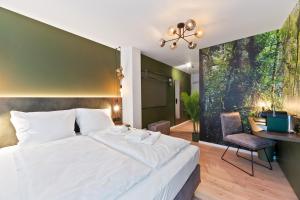 Postel nebo postele na pokoji v ubytování JUNGLE No5 Boutique Hotel - Stuttgart City-Center