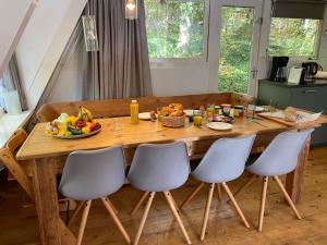 a wooden table with a bowl of fruit on it at 't Grote Egeltje XL chalet 220 in Durbuy