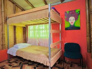 a bedroom with a bunk bed and a chair at Los Gulungos Hostel in Jardin