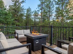 a patio with a fire pit on a deck at Mountain Serenity Retreat in Florissant