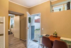 a home office with a table and a glass door at Appartio - Apartment für 2 - Küche - WiFi - Altstadtlage in Worms