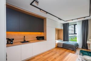 a kitchen with a sink and a bed in a room at Aviva Living by Flat Mаnager in Sofia
