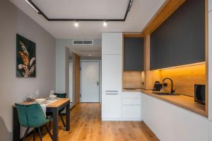 a kitchen and dining room with a table and a counter at Aviva Living by Flat Mаnager in Sofia