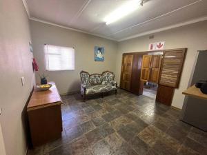 a living room with a couch in a room at Kelello House House in Welkom