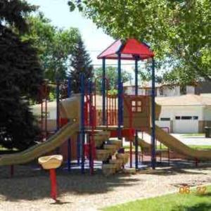 a playground with a slide in a park at Walk to Dining Breweries and Shops Plus New Hot Tub in Louisville