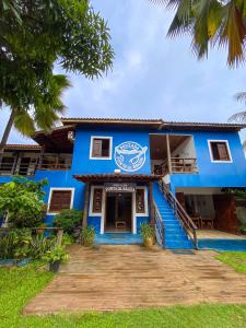 a blue building with a staircase in front of it at Pousada Ponta da Baleia in Barra Grande