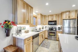 a kitchen with wooden cabinets and stainless steel appliances at Walk to Ski Lifts Cozy Crested Butte Condo in Crested Butte +13 photos