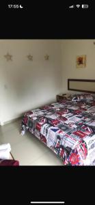 a bed with a comforter on it in a bedroom at Eco Paradise Cumbuco 128 in Cumbuco +9 photos