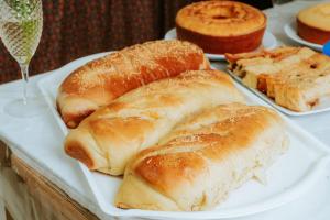 a white plate with pastries and bread on a table at Pousada Ponta da Baleia in Barra Grande