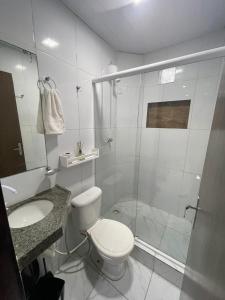 a bathroom with a shower and a toilet and a sink at Casa de praia Rocha Alves em Porto de Galinhas in Porto De Galinhas