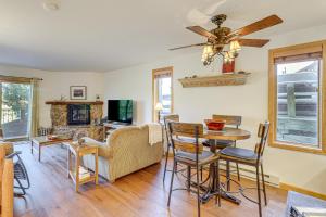 a living room with a ceiling fan and a table at Walk to Ski Lifts Cozy Crested Butte Condo in Crested Butte