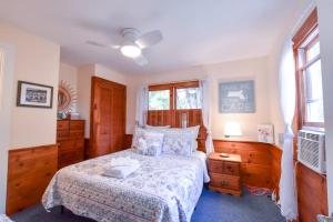 a bedroom with a large bed and a window at Bike to Nauset Beach or Walk to Mill Pond in Orleans