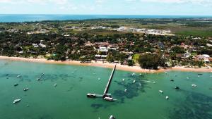 an aerial view of a beach with boats in the water at Pousada Ponta da Baleia in Barra Grande