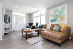 a living room with a couch and a table at Lux finishes 4 bedroom DSM home Great location in Des Moines