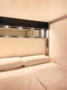 a bedroom with two beds with lights on the wall at Copenhagen Downtown Hostel in Copenhagen