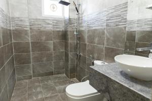 a bathroom with a sink and a toilet at Riviera Suites , Hotel Apartments in Sur +18 photos