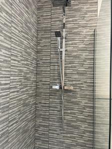 a shower in the corner of a bathroom at Belmont House in The Mumbles +53 photos