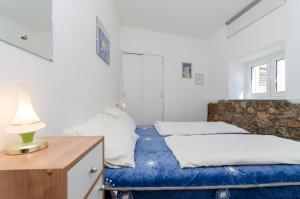 a bedroom with two beds and a desk with a lamp at House Ana in Kornić +36 photos