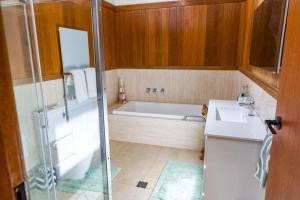 Un baño con bañera, lavabo y ducha. en Sea La Vie managed by Batemans Bay Accom, en Sunshine Bay 2 fotos más