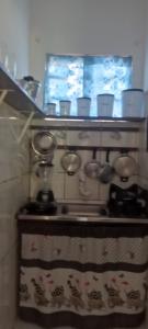 a kitchen stove with many knobs on the wall at BOIPEBA Cantinho do Mirko 1 in Cayru