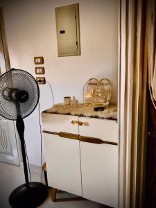 a room with a desk with a fan and a dresser at Nubian kingdom in Aswan +26 photos