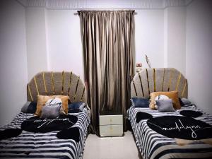 two beds sitting next to each other in a room at Nubian kingdom in Aswan
