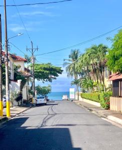 an empty street with a view of the ocean at Beach Lofts and Surf in Jacó