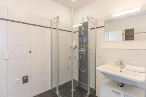 a bathroom with a shower and a sink at Carpe Diem in Husum +17 photos