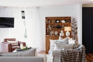 a living room with a couch and a chair at The Seafarer in Strahan