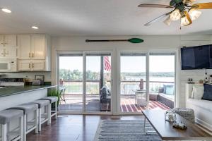 a kitchen and living room with a view of a porch at Lakefront Retreat-3bdrm 2ba with stunning views! Hiking & Fishing! in Falls of Rough