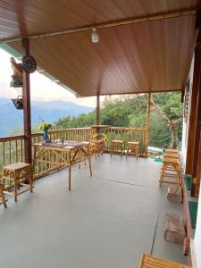 a porch with a view of the mountains at Cabaña el mirador del aguila in Quebradanegra +31 photos