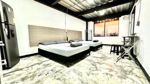 two beds in a room with a carpeted floor at Jardin Loft in Medellín +15 photos