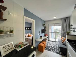 a small living room with a bed and a living room at Hospedagem 1710 - Vista Privilegiada e Localização in Sao Paulo