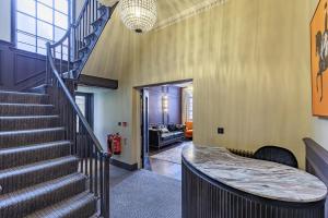 a hallway with a staircase and a stair case at The Seven Chester in Chester