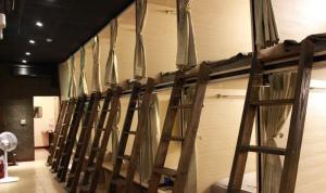 a row of wooden ladders lined up against a wall at FC Hostel-Ruifang Station in Ruifang