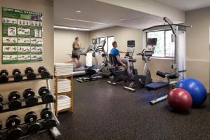 two men working out in a gym with weights at Holiday Inn & Suites Vancouver Downtown by IHG in Vancouver